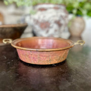 Early 20th-century French copper escargot pan with riveted brass handles and rich, timeworn patina.
