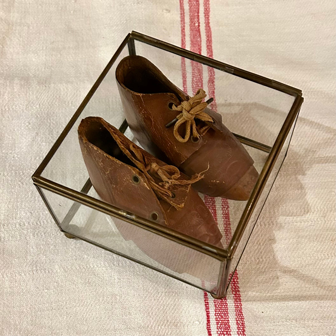 Antique leather baby shoes in display case
