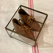 Antique leather baby shoes in display case