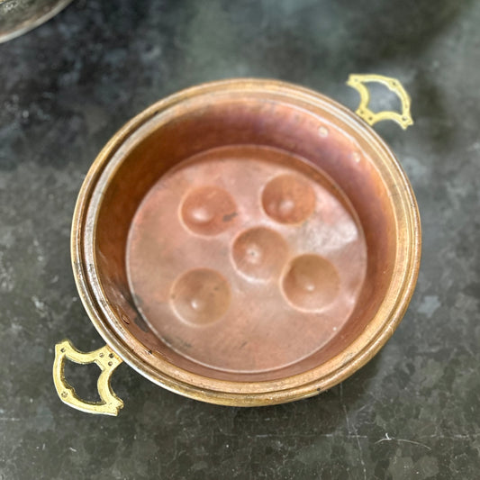 Early 20th-century French copper escargot pan with riveted brass handles and rich, timeworn patina.