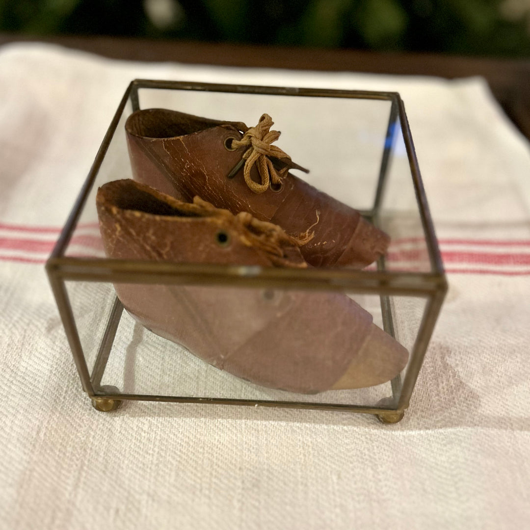 Antique leather baby shoes in display case
