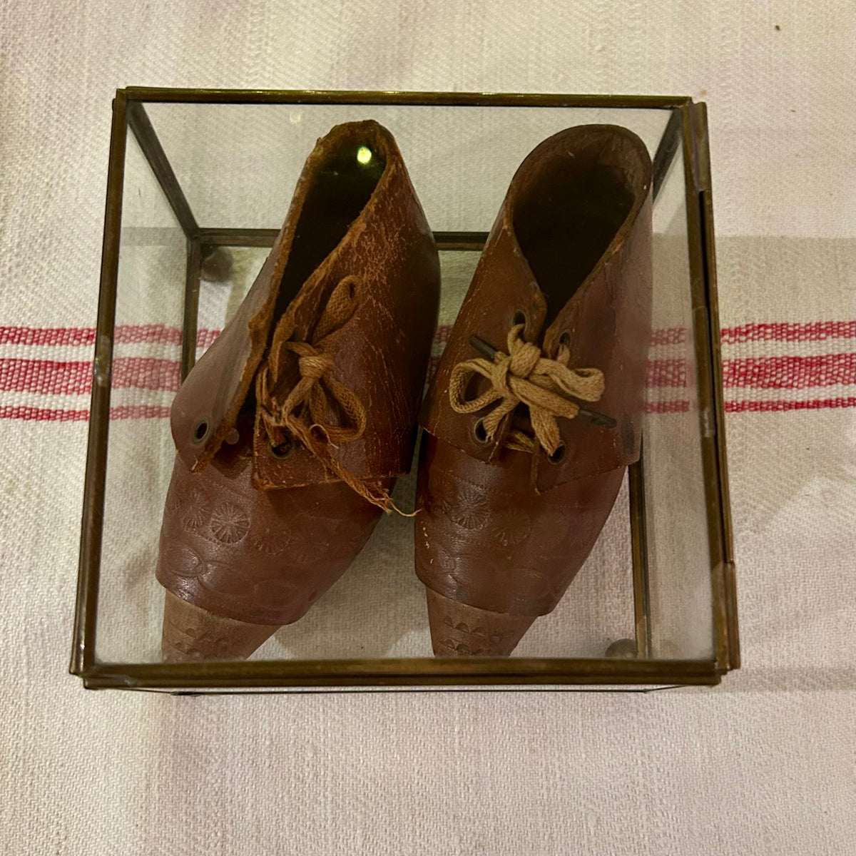 Antique leather baby shoes in display case