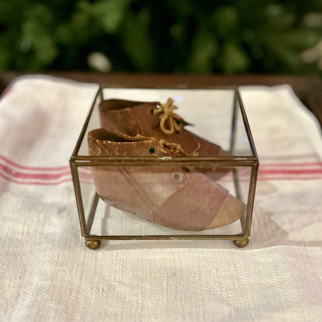 Antique leather baby shoes in display case