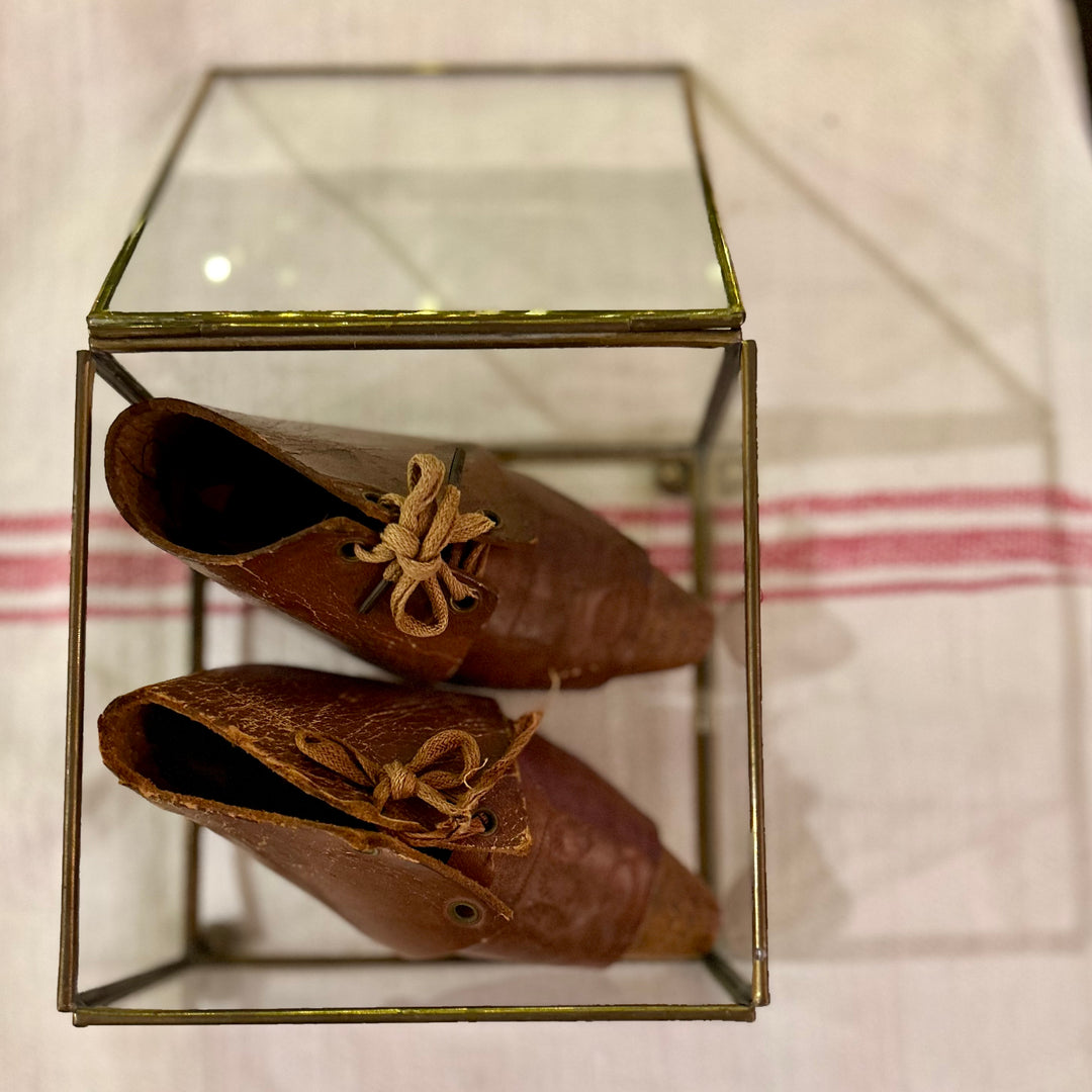 Antique leather baby shoes in display case